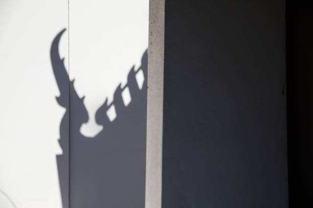 istock Shadow temple roof on white cement background. 641997204