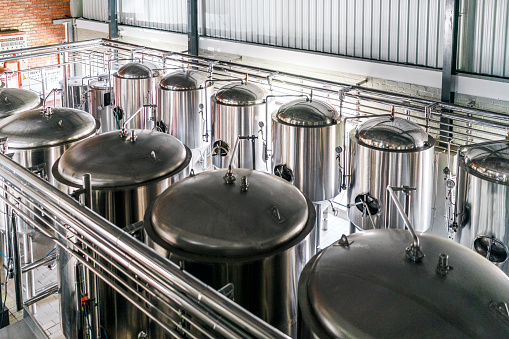 High angle view of metallic vats in brewery