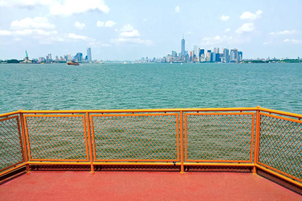 New York City, United States - March 21, 2009: Afternoon in New York, Staten Island Ferry with New York City Skyline in the background. The Staten Island Ferry is a passenger ferry service run by the New York City Department of Transportation between Manhattan and Staten Island.