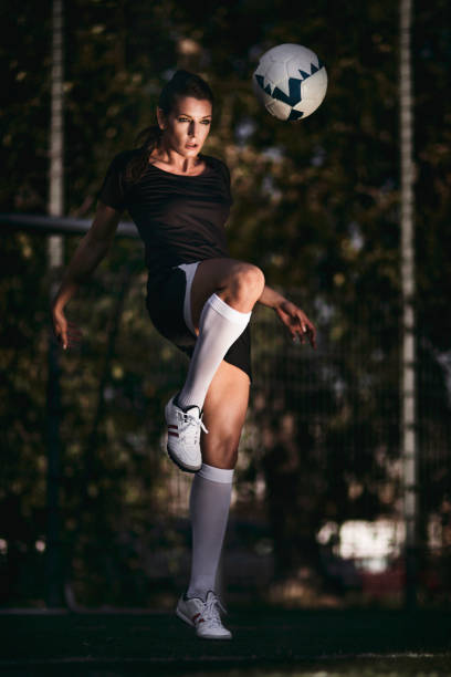 istock Female soccer player - ball juggling 642002028
