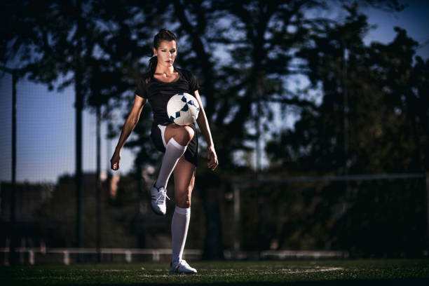 istock Female soccer player - ball juggling 642002318