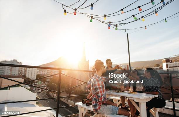 Young People Toasting Drinks At Party Stock Photo - Download Image Now - Friendship, Drinking, Beer - Alcohol