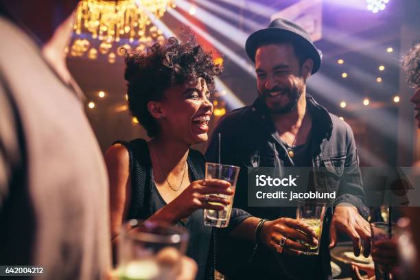 Group Of Young Friends On A Night Out Stock Photo - Download Image Now - Bar - Drink Establishment, Friendship, Nightlife