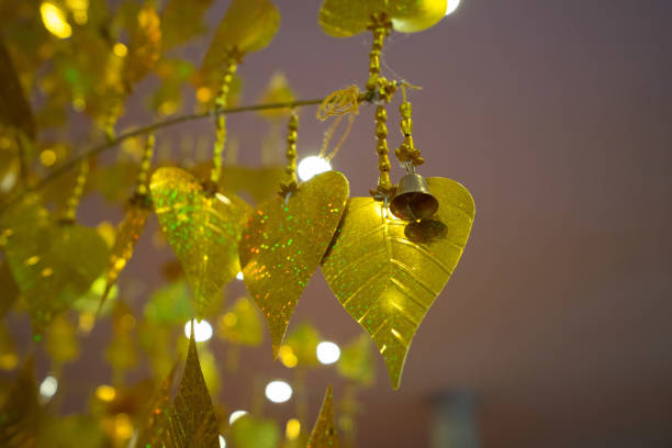 istock Gold pho leaves hanging on golden tree 642005832
