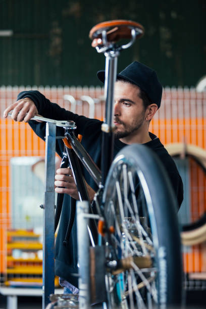 istock Close-up of bearded craftsman constructing bike 642006080