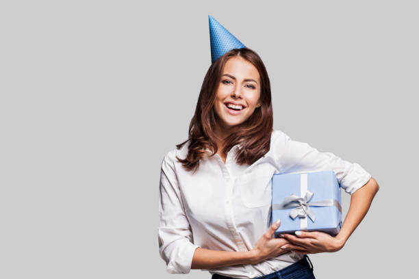 Happy woman with a gift Laughing girl woman with a gift box going on a party beautiful women giving head stock pictures, royalty-free photos & images