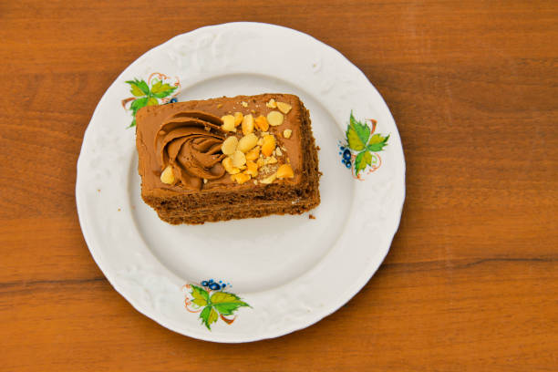 istock Piece of cake with nuts on plate on wooden table. Top view 642008662