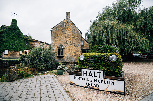 Bourton on the Water, UK - August 12, 2015: Motoring Museum a cloudy day near sunset.  It is a village and civil parish in Gloucestershire, England, that lies on a wide flat vale within the Cotswolds Area of Outstanding Natural Beauty.