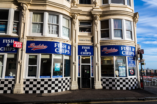Exterior shot of a fish and chips restaurant in Brighton, UK. Fish and chips is one of the most traditional meals in Great Britain, and there are many opportunities to sample it in Brighton, on the south coast of England. Horizontal colour image with copy space.