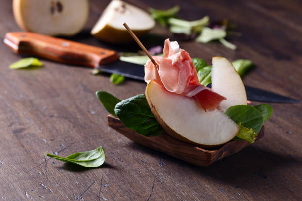 prosciutto with pear on a old wooden table