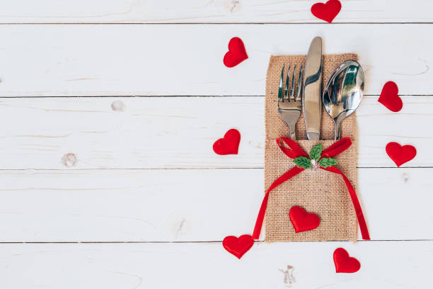 istock Above wood table set silverware and red heart for valentine day with space. 642011714