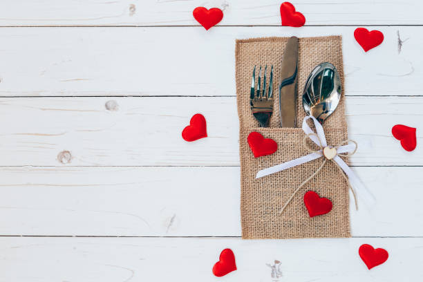 istock Above wood table set silverware and red heart for valentine day with space. 642011716