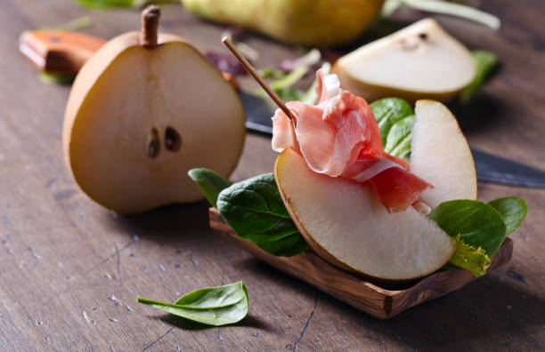 istock prosciutto with pear on a wooden table 642011730