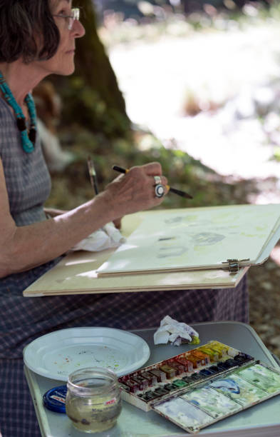 istock Senior woman painting, vertical 642016954