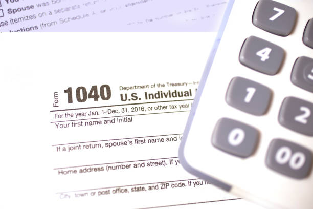 istock Income Tax forms, calculator close-up view. 642027556