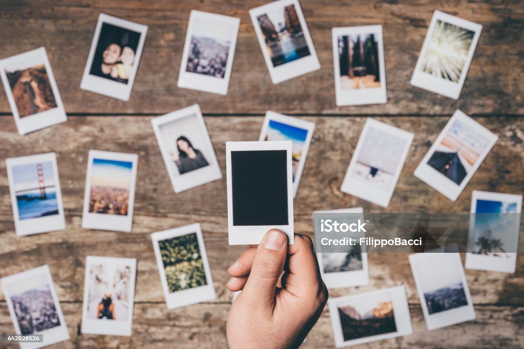 Instant camera prints on a table Instant camera prints on a table. Top view. Instant Camera Stock Photo
