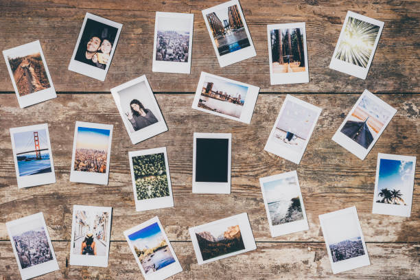 Instant camera prints on a table Instant camera prints on a table. Top view. cirrocumulus stock pictures, royalty-free photos & images