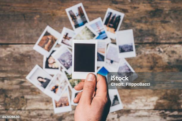 Instant Camera Prints On A Table Stock Photo - Download Image Now - Instant Print Transfer, Instant Camera, Black Color