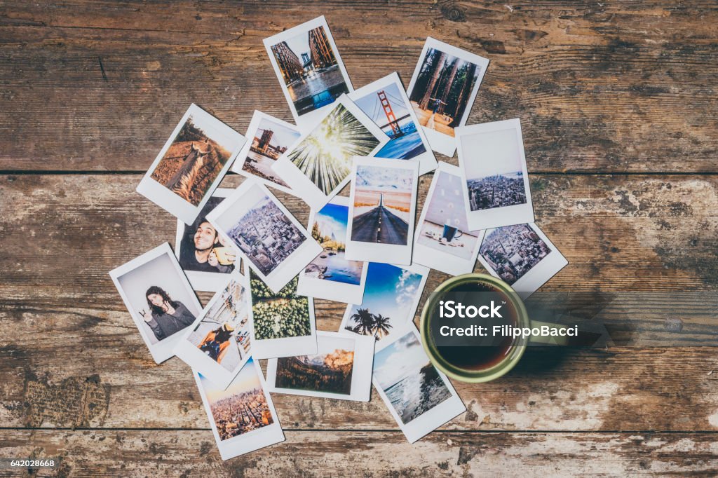 Instant camera prints on a table Instant camera prints on a table. Top view. Instant Camera Stock Photo