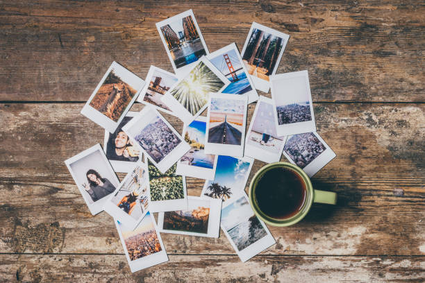Instant camera prints on a table Instant camera prints on a table. Top view. table photos stock pictures, royalty-free photos & images