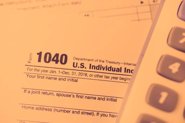 istock Income Tax forms, calculator close-up view. 642029098