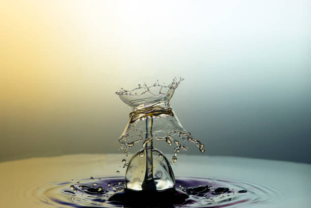 istock Collision of two drops on a surface of water 642030980