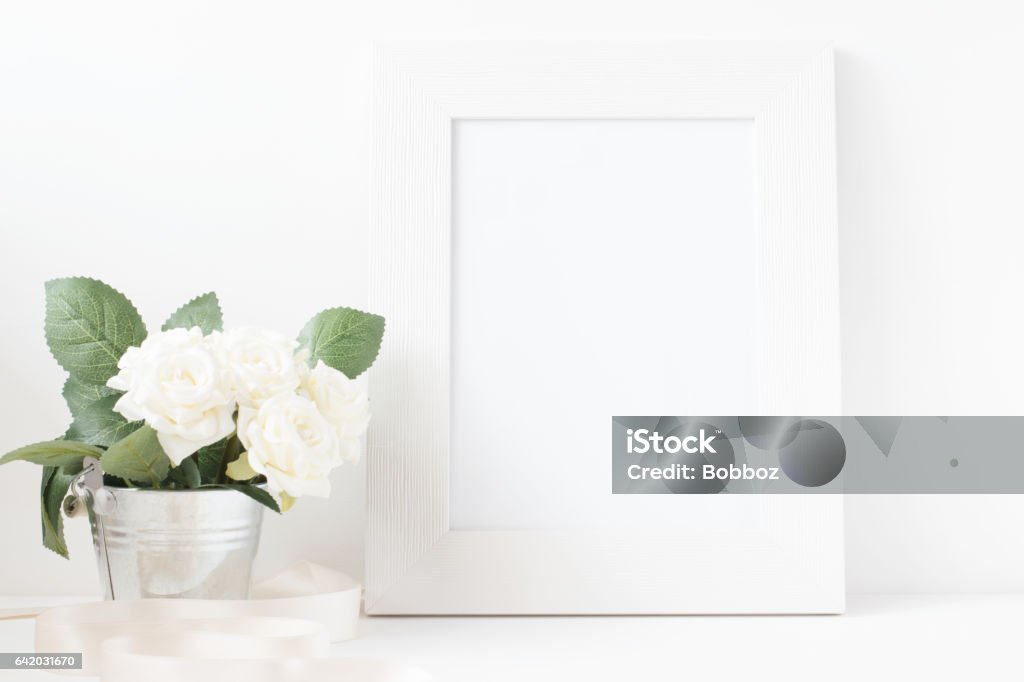 Picture Frame With Flower Bouquet. Picture frame with flower bouquet on wooden table. Abstract Stock Photo