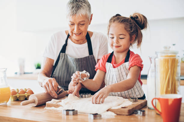 istock Grandma, let me help you with the cookies! 642034928