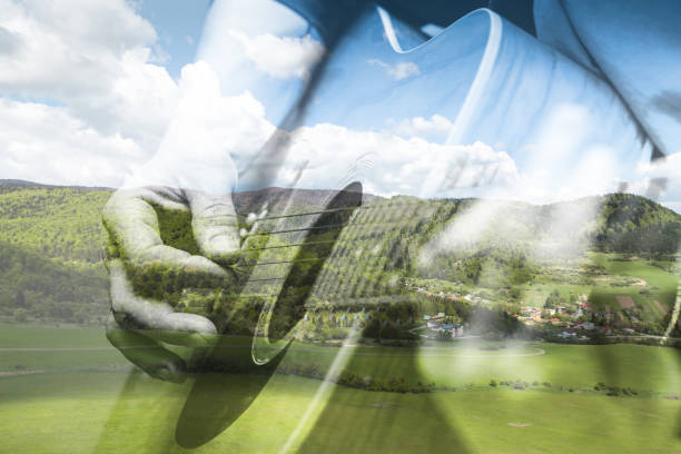 istock Double Exposure guitarist playing guitar in the mountains on a trip. 642036418