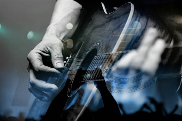 istock Guitarist with the audience in a double exposure. 642036420