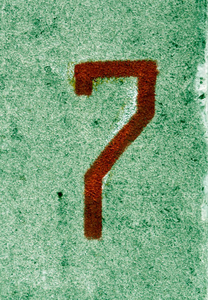 istock Number seven on green cement wall 642038174