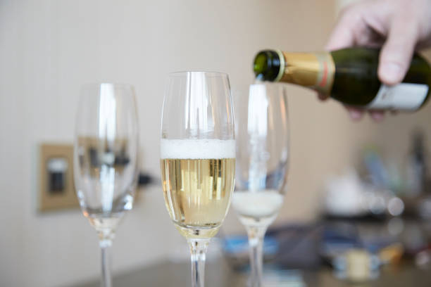 istock Waiter serving champagne in three glasses 642044422