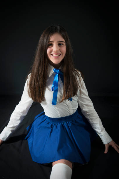 A little girl 12 Y in dancing uniform is in a dancing posing