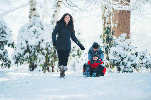 istock Mom and sons playing in snow 642050026
