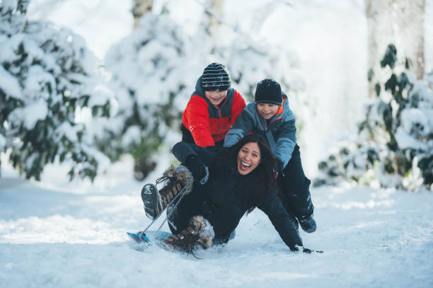 istock Mom and sons playing in snow 642050036