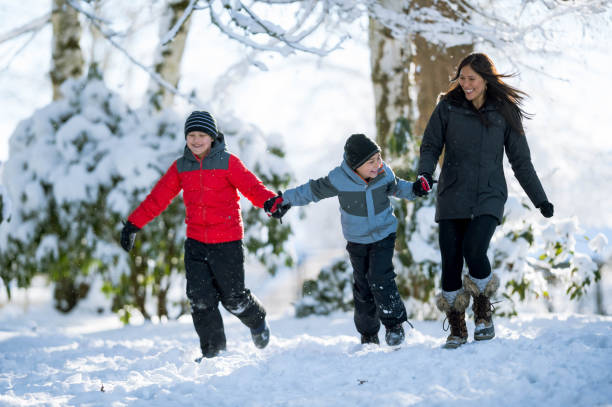 istock Mom and sons playing in snow 642050062