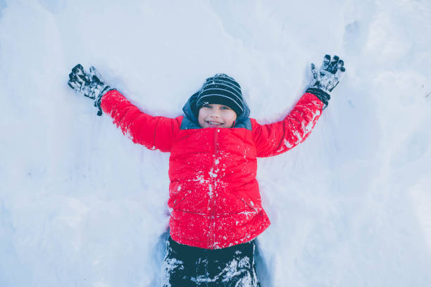 istock Young woman playing in snow 642050090
