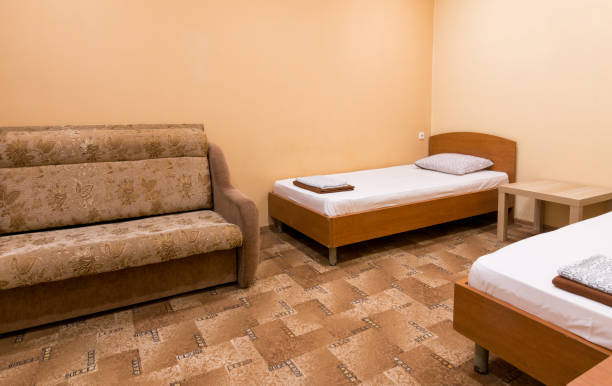 istock The interior of a small room with a sofa and two beds 642054756