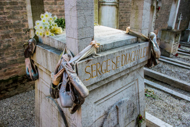 Close up of corner of the grave of Sergei Diaghilev, San Michele Cemetery,Venice. Diaghilev was a legendary dance figure who worked with Ravel, Stravinsky and Prokofiev and founded the Ballet Russes in Paris. Traditionally ballet shoes and red roses are left on his grave.