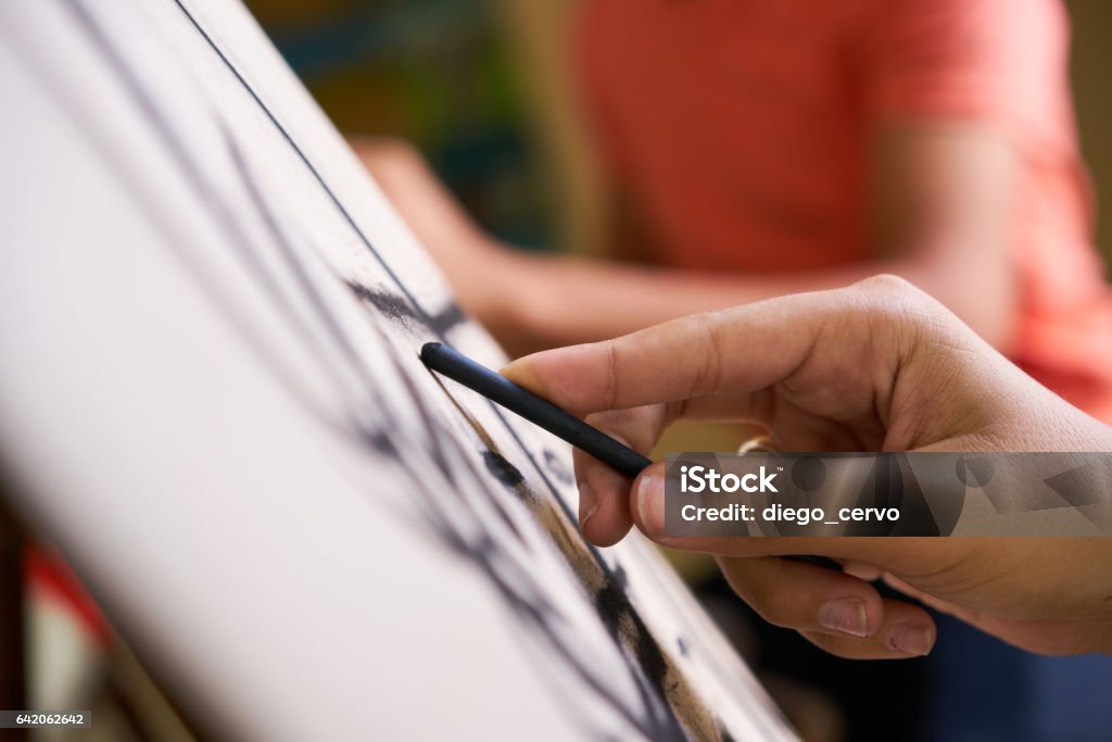 Male Hand Drawing Young Man Sketching Artist Training At School School of art, college of arts, education for group of young students. Man sketching for fun, student drawing for hobby. Close up of hand Drawing - Activity Stock Photo