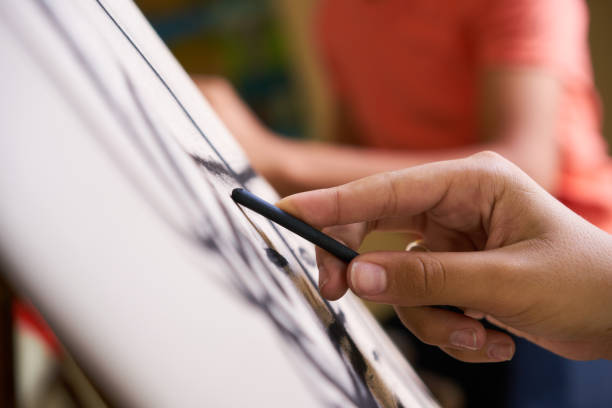 Male Hand Drawing Young Man Sketching Artist Training At School School of art, college of arts, education for group of young students. Man sketching for fun, student drawing for hobby. Close up of hand drawing artistic product stock pictures, royalty-free photos & images