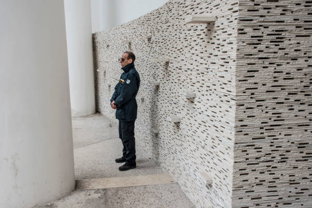 Guard at the 2016 venice Architecture Biennale. Guard at the 2016 Venice Architecture Biennale. The wall behind him is made of compressed waste from the 2015 exhibition. venice biennale stock pictures, royalty-free photos & images