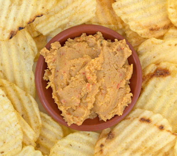 istock Hummus dip in a bowl with potato chips close view 642064300