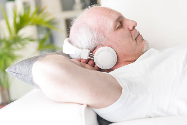 istock mature man relaxing with music and closed eyes 642066360