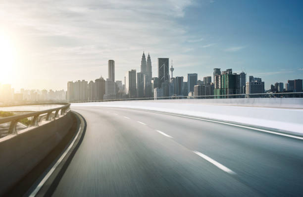 istock Highway overpass motion blur with city background . sunset scene . 642068120