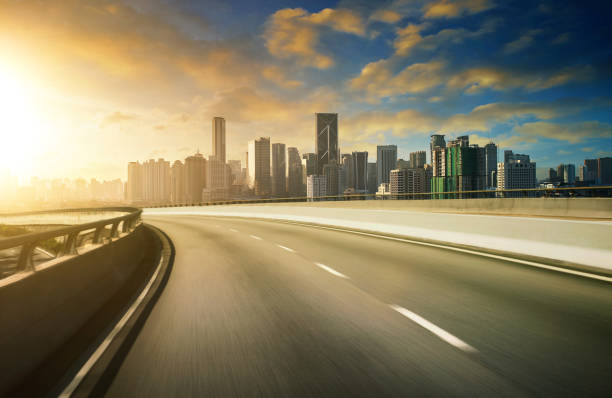istock Highway overpass motion blur with city background . sunset scene . 642068124