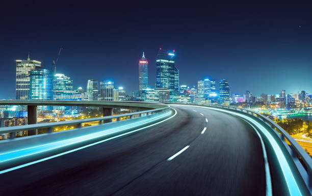 istock Highway overpass motion blur with city background . night scene . 642068176