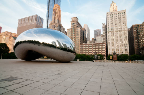 Chicago Chicago, USA - August 26, 2016: The Bean and Chicago skyline early in the day in Millennium Park just after sunrise. millennium park stock pictures, royalty-free photos & images