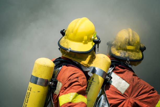 istock two firefighters fire fighting suround with dark smoke 642079226