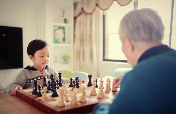 istock Children playing with chess 642088750